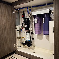 Enclosed water system with dual filtration, pressure pump, and marine plumbing