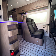 Interior view of modern camper van with LED accents and twin bench seats
