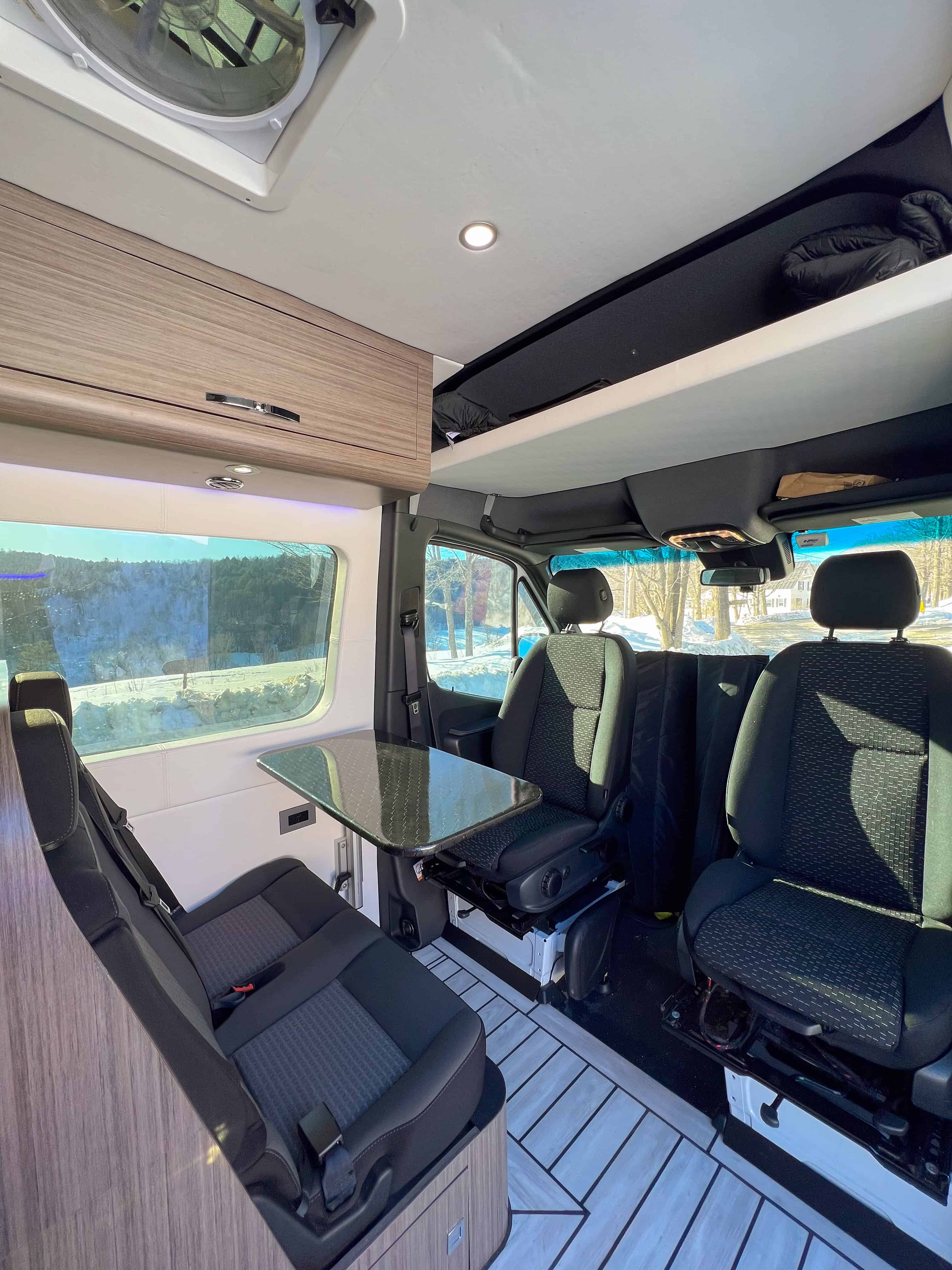 Interior view of four captain’s seats with stowable table and panoramic window
